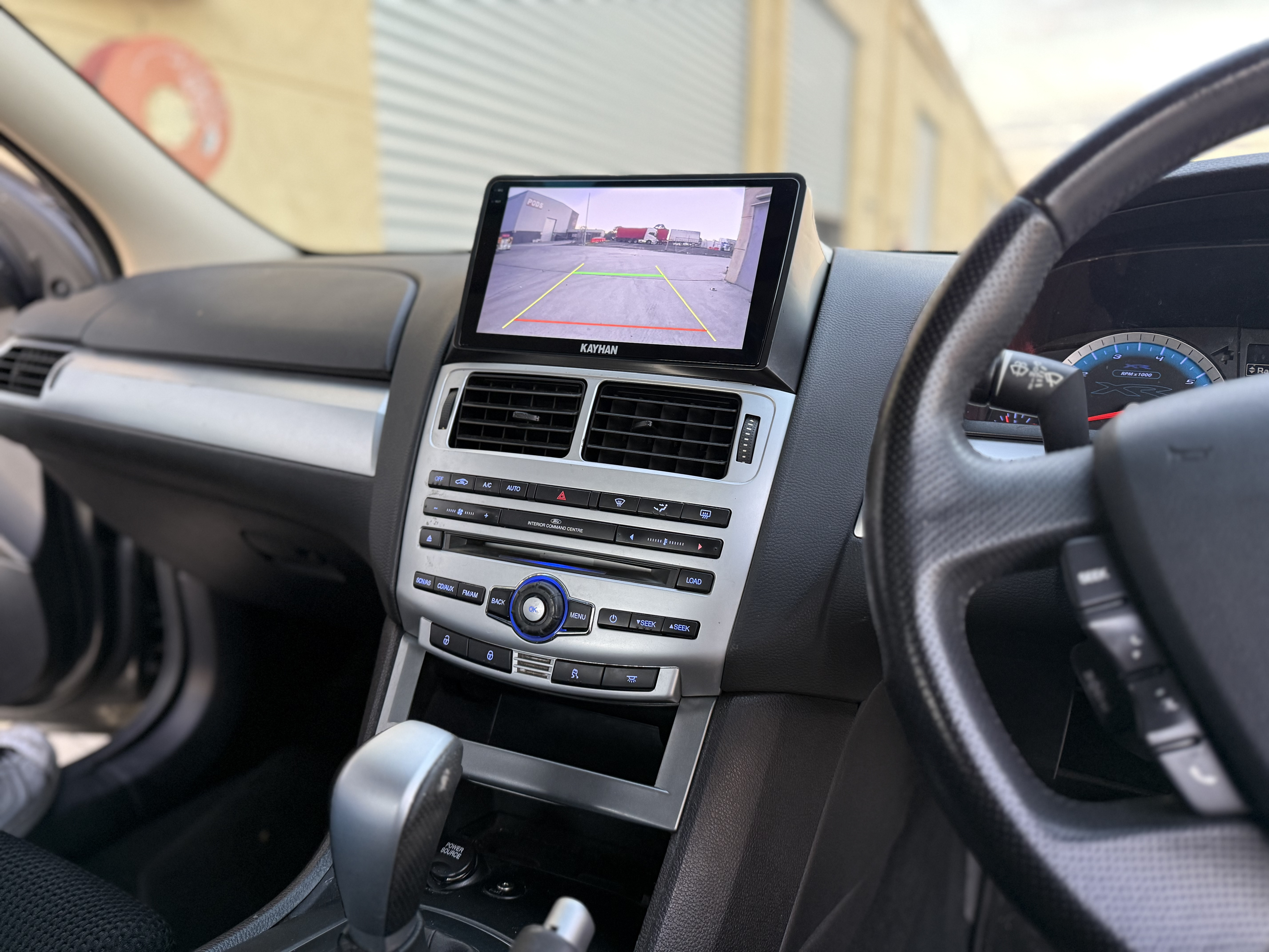 Kayhan Audio Linux head unit in Ford Falcon FG MK1 displaying reversing camera view with parking guidelines